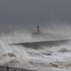 Huge waves batter the coast of England.